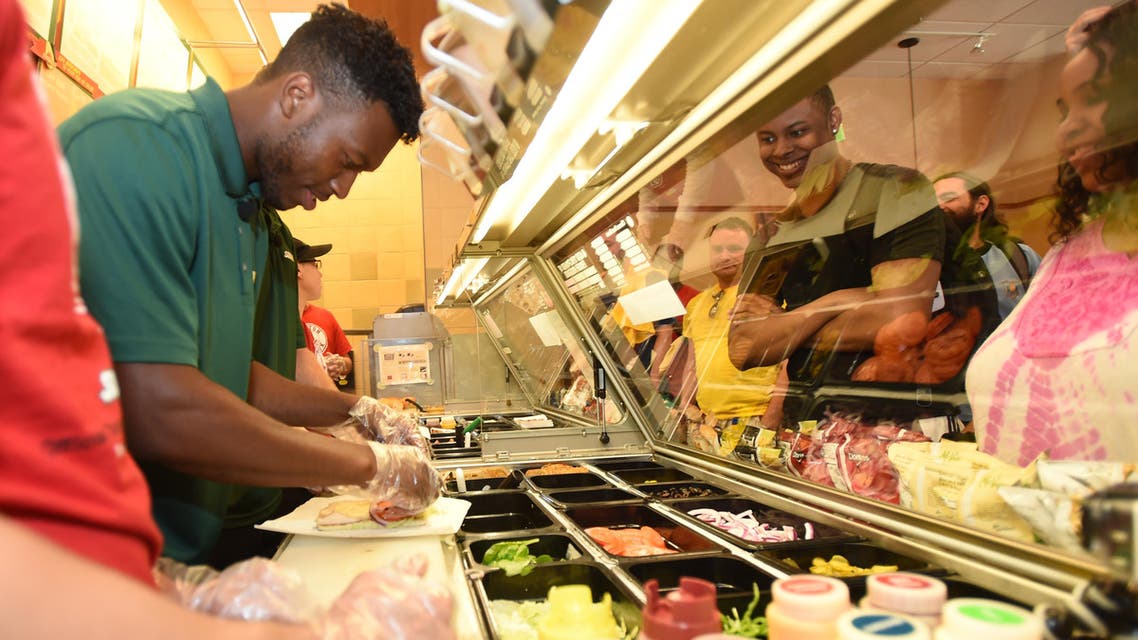Liverpool FC Striker Daniel Sturridge prepares a sandwich for a fan at a Subway Restaurant on Friday, July 25, 2014 in Boston. (File Photo; AP)