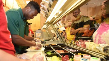 Liverpool FC Striker Daniel Sturridge prepares a sandwich for a fan at a Subway Restaurant on Friday, July 25, 2014 in Boston. (File Photo; AP)