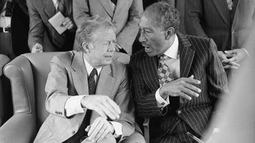 President Jimmy Carter and Anwar Sadat hold an animated conversation during their train ride from Cairo to Alexandria in Egypt, Friday, March 9, 1979. (File Photo; AP)