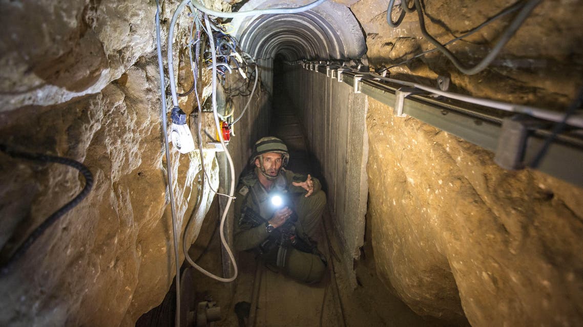 An Israeli army officer gives journalists a tour, Friday, July 25, 2014, of a tunnel allegedly used by Palestinian militants for cross-border attacks, at the Israel-Gaza Border. A network of tunnels Palestinian militants have dug from Gaza to Israel, dubbed "lower Gaza" by the Israeli military, is taking center stage in the latest war between Hamas and Israel. (AP Photo/Jack Guez, Pool)
