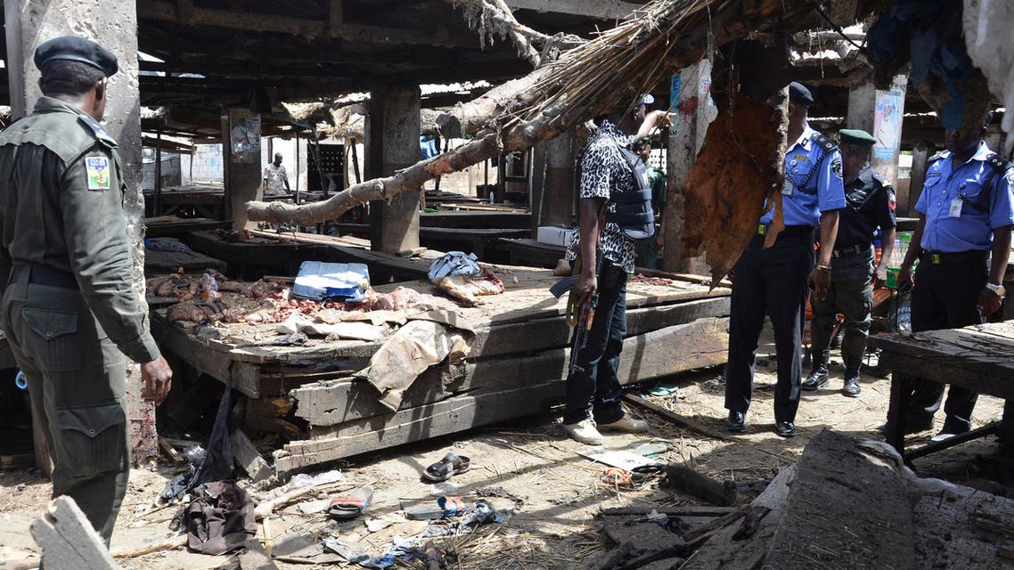 Police officers inspect the site of a suicide bomb attack at a market in Maiduguri , Nigeria, Tuesday, June 2, 2015. AP
