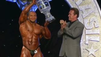Arnold Schwarzenegger awards trophy to Egyptian bodybuilder 