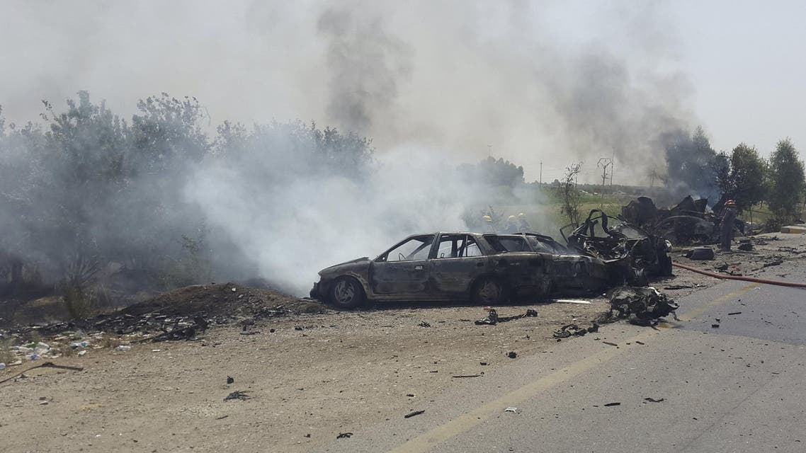 Smoke rises from the site of a car bomb attack on the outskirt of Diyala province May 24, 2015. (AP)