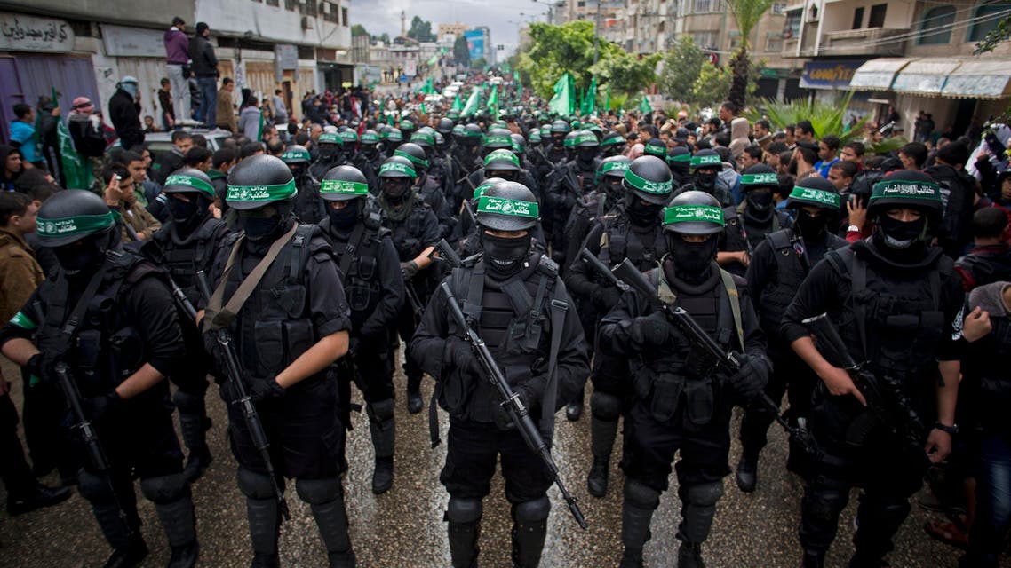 In this Dec. 14, 2014 file photo, masked Palestinian Hamas gunmen perform their military skills during a rally to commemorate the 27th anniversary of the Hamas militant group, in Gaza City AP
