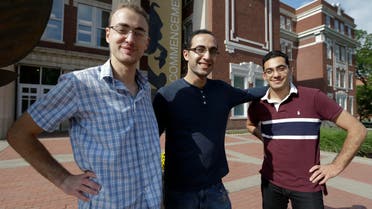 Syrian brothers Mohammad Kayali, left, Ebrahim Kayali, right and Molham Kayali, center, pose for a photograph on the Emporia State University campus in Emporia, Kan. (AP)