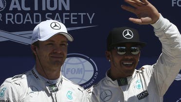 Mercedes F1 driver Lewis Hamilton of Britain poses with team mate Nico Rosberg of Germany after qualifying for pole position ahead of the Canadian F1 Grand Prix in Montreal. (Reuters)