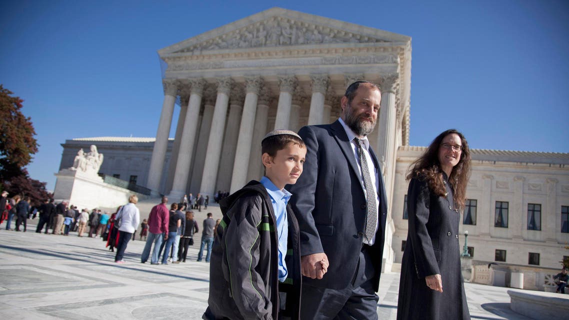 Ari Zivotofsky, center, walks with his nine-year-old son, Menachem, outside the Supreme Court in Washington, Monday, Nov. 7, 2011. AP