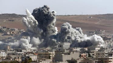 Thick smoke from an airstrike by the US-led coalition rises in Kobani, Syria, as seen from a hilltop on the outskirts of Suruc, at the Turkey-Syria border, Wednesday, Oct. 22, 2014. AP