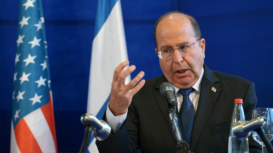 In this file photo taken Thursday, May 15, 2014, Israeli Defense Minister Moshe Yaalon speaks during a joint press conference with U.S. Defense Secretary Chuck Hagel following a meeting at the Israeli Defense Force headquarters in Tel Aviv, Israel. AP