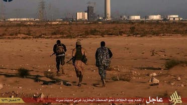  An image taken from jihadist media outlet Wilayat Trablus and provided courtesy of the US-based monitoring agency SITE Intelligence Group on June 9, 2015 allegedly shows Islamic State (IS) group fighters running towards what they say is a power plant in the southern Libyan city of Sirte after IS claimed to have seized full control of the city from Fajr Libya militia. AFP 