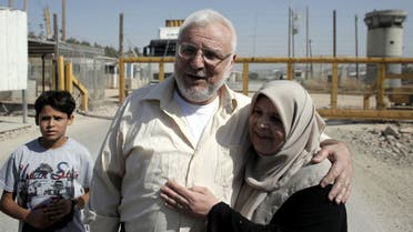  Aziz Dweik (C), speaker of the Palestinian Legislative Council, hugs a relative after he was released from Israeli prison outside the compound of the Israeli Ofer Military Prison, near the West Bank city of Ramallah, on June 9, 2015. (AFP)