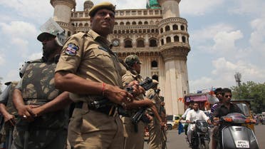 Indian policemen stand guard in front of the landmark Charminar during Friday prayers at Mecca Masjid in Hyderabad, India, Friday, April 10, 2015. Security was increased as a preventive measure on the first Friday following the killing of five prisoners, including one accused of terrorism, when, according to the police, they tried to escape from a police van on Tuesday. (AP Photo/Mahesh Kumar A.)