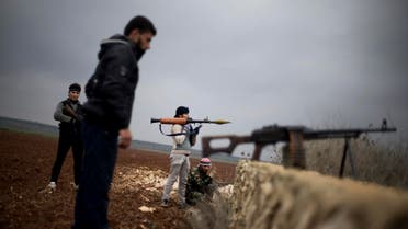 In this Dec. 10, 2012, Free Syrian Army fighters take their positions, close to a military base, near Azaz, Syria. (File Photo: AP)