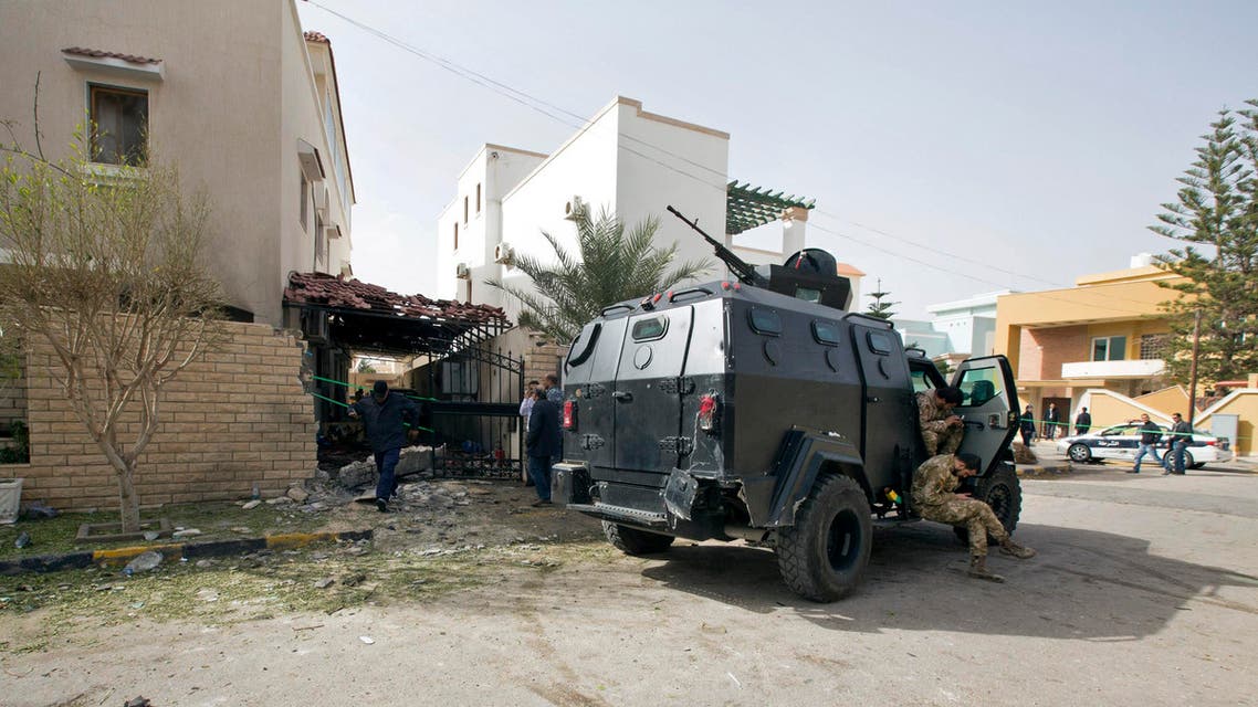 Security Personnel guard the Iranian ambassador's house after it received minor damage caused by an improvised explosive device placed among garbage bags, in Tripoli, Libya, Sunday, Feb. 22, 2015. AP