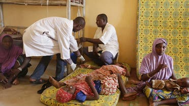 A Sunday, May 3, 2015 photo from files showing doctors as they attend to a sick child rescued by Nigerian soldiers from Boko Haram extremists at a refugee camp in Yola, Nigeria after being rescued from captivity by Boko Haram fighters. AP