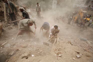 People search for survivors under the rubble of houses destroyed by Saudi airstrikes in the old city of Sanaa, Yemen, Friday, June 12, 2015. (AP Photo/Hani Mohammed)