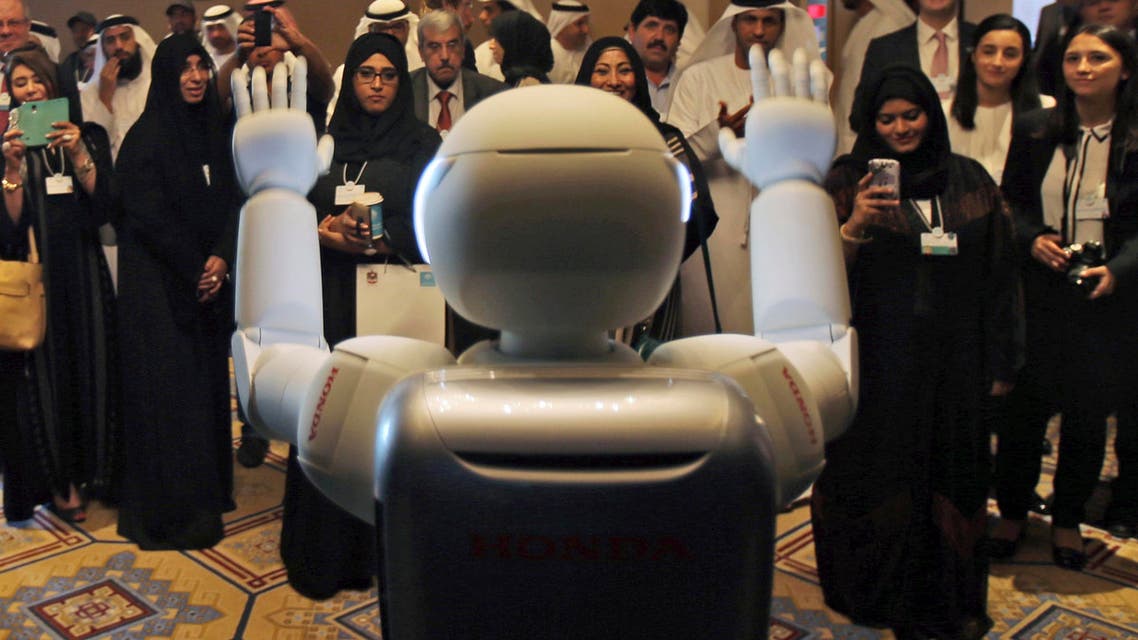 A humanoid robot designed and developed by Honda and named Asimo waves for the audience at the end of the company's presentation during the last day of the Government Summit in Dubai, Feb. 11, 2015. (