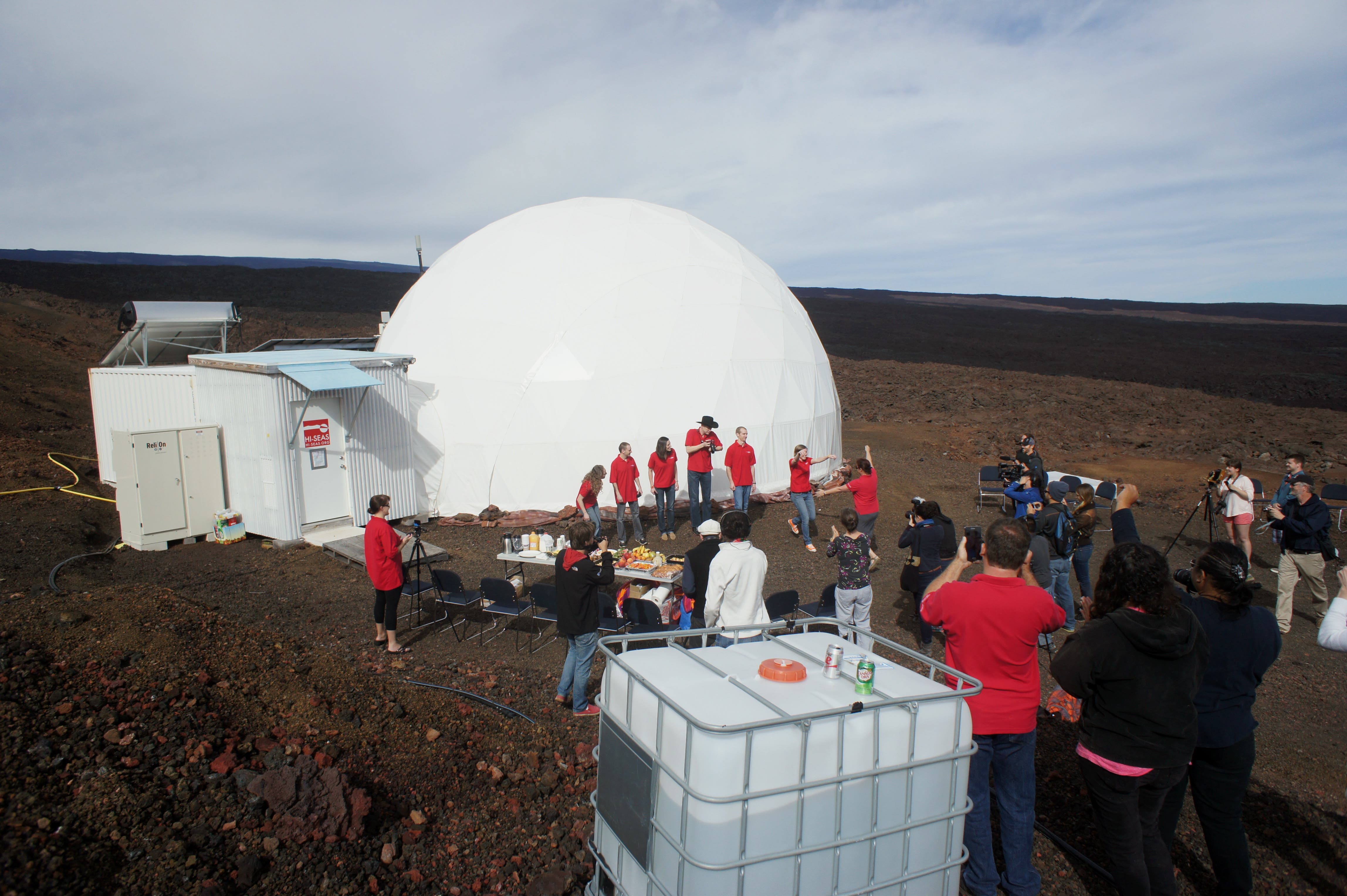 In this photo provided by the University of Hawaii at Manoa HI-SEAS Human Factors Performance Study, six scientists exit a dome that they lived in as part of an isolated existence to simulate life on a mission to Mars, on the bleak slopes of dormant volcano Mauna Loa near Hilo on the Big Island of Hawaii, Saturday, June 13, 2015. The scientists who took part of a human performance study funded by NASA, stepped outside the dome at 8,000 feet elevation to feel fresh air on their skin Saturday, the first time they'd ventured out without donning a space suit in eight months. (Ryan Ogliore/University of Hawaii at Manoa via AP) MANDATORY CREDIT