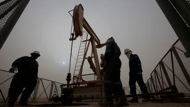 men work on an oil pump during a sandstorm in the desert oil fields of Sakhir, Bahrain. The price of oil dipped below $45 a barrel Tuesday, Jan. 13, 2015, following the latest sign from OPEC that the group doesn’t plan to cut production. (AP Photo/Hasan Jamali, File)
