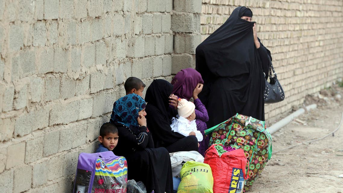 In this file photo taken Wednesday, March 18, 2015, internally displaced people who fled from Tikrit, Iraq, because they feared Islamic State militants settle at a refugee camp outside Baghdad, Iraq. AP