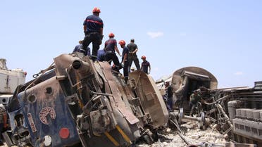 Rescuers work at the site of a collision between a passenger train and a truck in the southern city of Fahs, Tunisia, June 16, 2015. Reuters