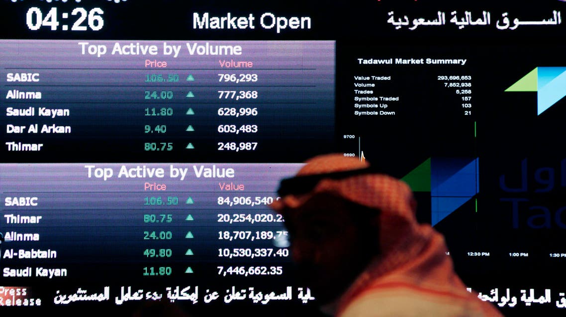 A Saudi man looks at stocks at the Tadawul Saudi Stock Exchange, in Riyadh, Saudi Arabia, Monday, June 15, 2015. Saudi Arabia's stock market, valued at $585 billion, opened up to direct foreign investment for the first time Monday, as the kingdom seeks an economic boost amid low global oil prices. (AP Photo/Hasan Jamali)