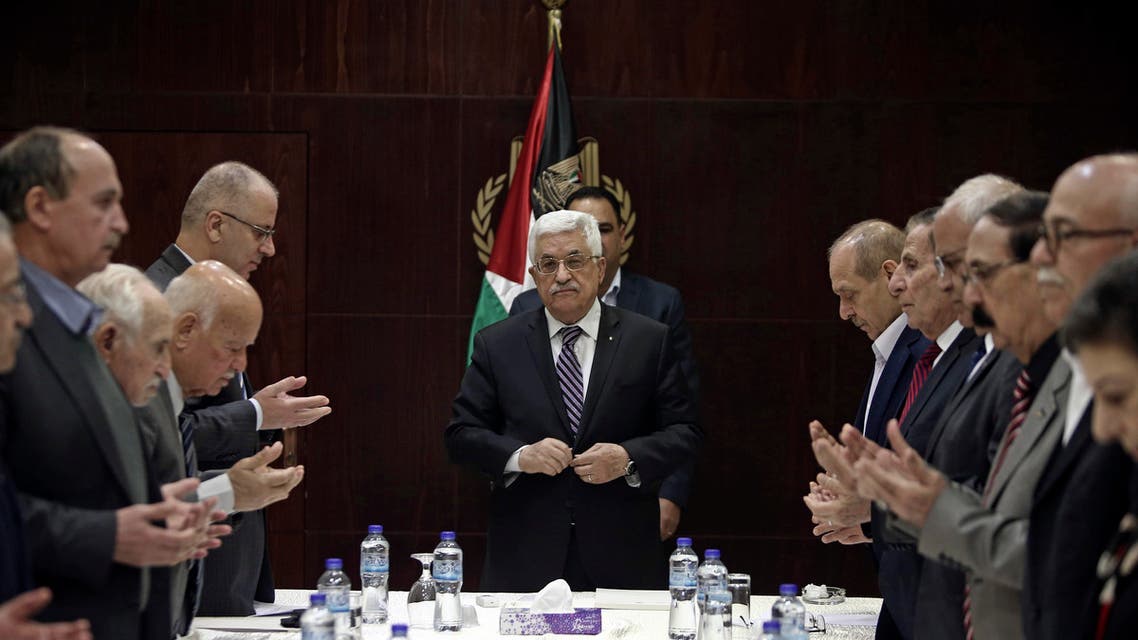 Palestinian President Mahmoud Abbas, center, joins in reading from the Quran prior to a meeting of the PLO executive committee in the West Bank city of Ramallah, Saturday, April 18, 2015. (AP)