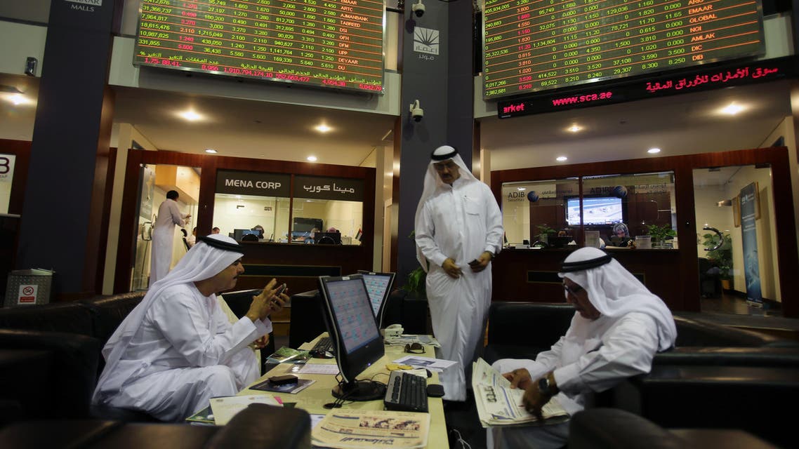 In this Thursday, Oct. 2, 2014 file photo, Emirati traders check the stocks of Emaar Malls on the screen at the Dubai Financial Market in United Arab Emirates. (AP)