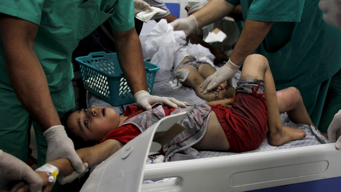 Palestinian doctors treat children wounded in an Israeli airstrike on a building, at the treatment room of al Najar hospital in Rafah in the southern Gaza Strip, Thursday, Aug. 21, 2014. (File: AP)
