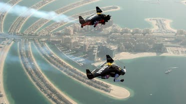 An aerial view taken from a sea plane shows Swiss pilot and original Jetman Yves Rossy (front) and Vince Reffett flying over Dubai's Palm Island, Dubai, United Arab Emirates May 12, 2015.