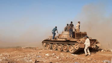 Members of the Libyan pro-government forces stand on a tank during their deployment in the Lamluda area, southwest of the city of Derna, Libya, June 16, 2015. (File: Reuters)