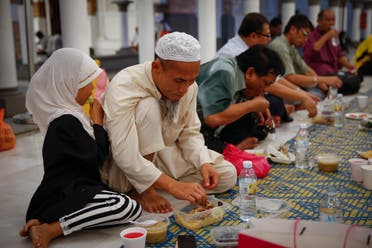 Malaysian muslim family breaking their fast on the first day of the holy Islamic month of Ramadan in Kuala Lumpur, Malaysia, on Thursday, June 18, 2015. AP