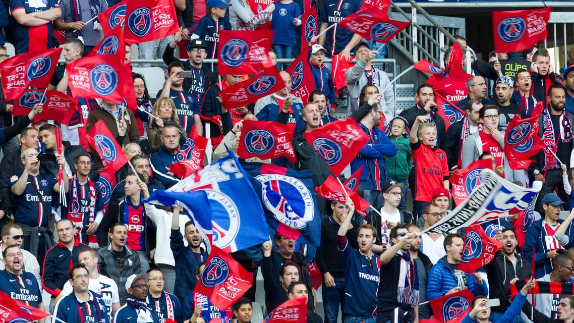 Paris Saint Germain (PSG) fans celebrate during the French Cup final soccer match between PSG and Auxerre at the Stade de France Stadium, in Saint Denis, north of Paris, Saturday May 30, 2015. PSG won 1-0. (AP Photo/Jacques Brinon)