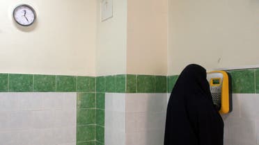 An Iranian female prisoner makes a call in a corridor in the Evin prison in Tehran, Iran. (File: AP)