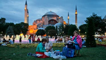 People break their fast backdroped by the Byzantine-era Hagia Sophia, in the historic Sultanahmet district of Istanbul, Turkey, Thursday, June 18, 2015. (AP)