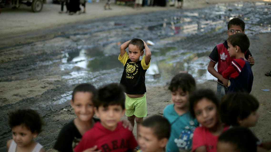 In this Wednesday, Sept. 3, 2014 photo, Palestinian children play outside a U.N. school in Gaza City where they live after their houses were destroyed by Israeli strikes. AP