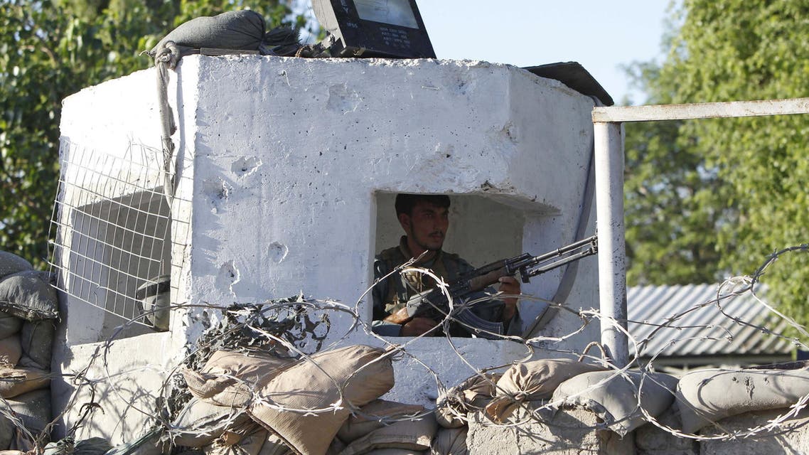 An Afghan policeman keeps watch after a suicide attack on a police headquarters in Jalalabad, Afghanistan June 1, 2015. (Reuters)