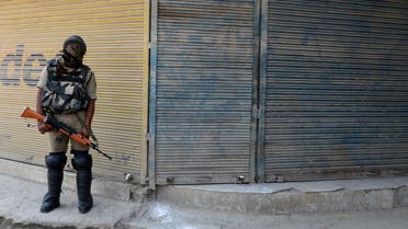    TM3181 - Srinagar, jammu and kashmir, INDIA : An Indian paramilitary trooper stands guard in front of shuttered shops in Srinagar on June 17, 2015 during a one-day strike called by seperatist groups against a recent spate of mysterious killings in Indian-administered Kashmir. Six former rebels and seperatist activists have been killed in Sopore area of the disputed region during the last three weeks.AFP PHOTO/Tauseef MUSTAFA  	