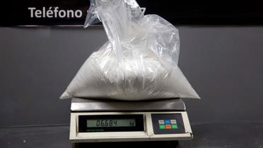 In this Jan. 26, 2014 photo, a bag of cocaine that was found in the baggage of Liz Rabines, from Spain, sits on a scale at the anti-narcotics police station inside the Jorge Chavez International Airport in Lima, Peru.