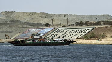 A ferry transporting cars and people crosses the Suez Canal in the Egyptian port city of Ismailia, east of Cairo. (File photo: AFP)