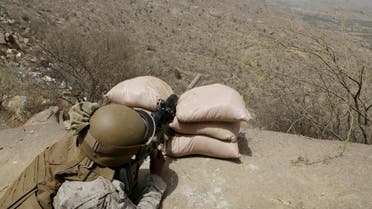A Saudi soldier aims his weapon from behind a sandbag barricade at the border with Yemen in Jazan, Saudi Arabia, Monday, April 20, 2015. AP