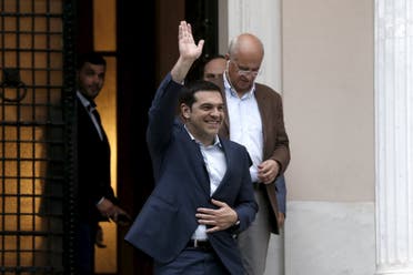 Greek Prime Minister Alexis Tsipras waves to people cheering as he leaves his office at the Maximos Mansion following a governmental council in Athens June 21, 2015. (Reuters)