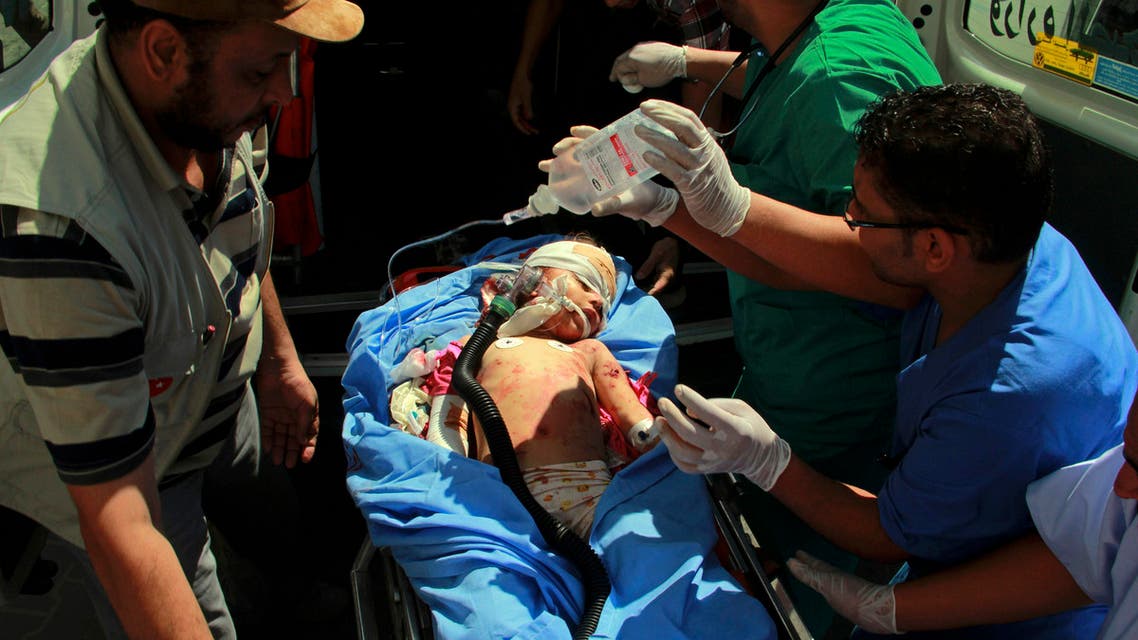 Medics treat a Palestinian child wounded in shelling in Rafah, southern Gaza Strip, Saturday, Aug. 2, 2014. AP