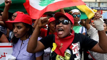 Migrant domestic workers chant slogans as they carry Lebanese flags during a march demanding basic labor rights as Lebanese workers in Beirut, Lebanon, Sunday, May 3, 2015.AP