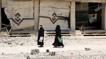 Two women walk at a site hit by what activists said was an airstrike by forces loyal to Syria's President Bashar al-Assad, at the eastern Ghouta of Damascus June 5, 2015. (Reuters) 