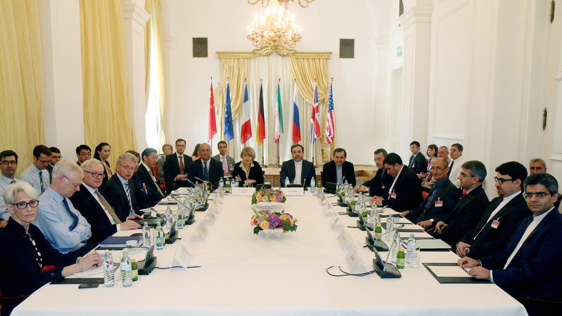 In this Friday, June 12, 2015 file photo delegates sit around a table prior to a bilateral meeting as part of the closed-door nuclear talks with Iran at a hotel in Vienna, Austria. Iran and six powers are still apart on all main elements of a nuclear deal with less than two weeks to go to their June 30 target date and will likely have to extend their negotiations, two diplomats tell The Associated Press. (AP Photo/Ronald Zak, File)