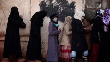 In this Wednesday, Dec. 12, 2012, file photo, Syrian women wait outside a bakery shop to buy bread in Maaret Misreen, near Idlib, Syria. (AP)