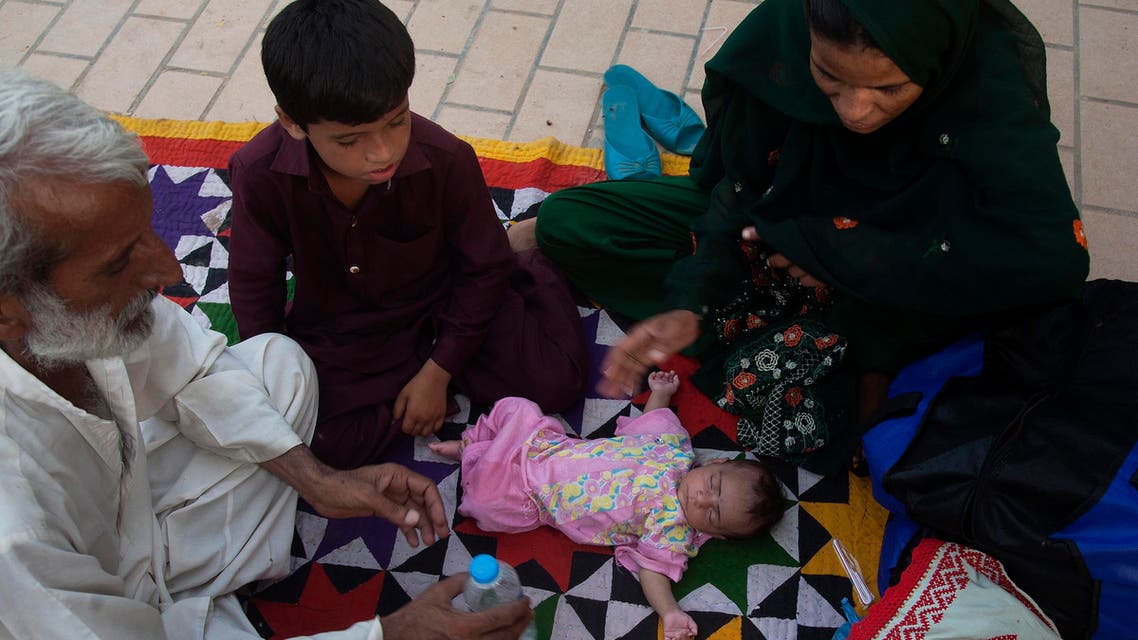 Family members surround a child suffering from dehydration due to sever heat, at a local hospital in Karachi, Pakistan, Tuesday, June 23, 2015. AP