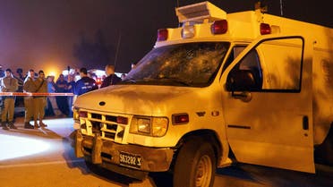 Israeli security personnel check an Israeli military ambulance which was attacked by Israeli Druze in the Israeli settlement of Neve Ativ, near Majdal Shams on the Israeli-annexed Golan Heights, as it was on its way to a hospital carrying two injured Syrians for treatment on June 22, 2015. Public radio earlier said that around 200 Druze from Majdal Shams had pelted the ambulance with stones, forcing it to stop, and dragged the wounded Syrians from the vehicle leaving one dead and the other in a serious condition. AFP PHOTO / STR