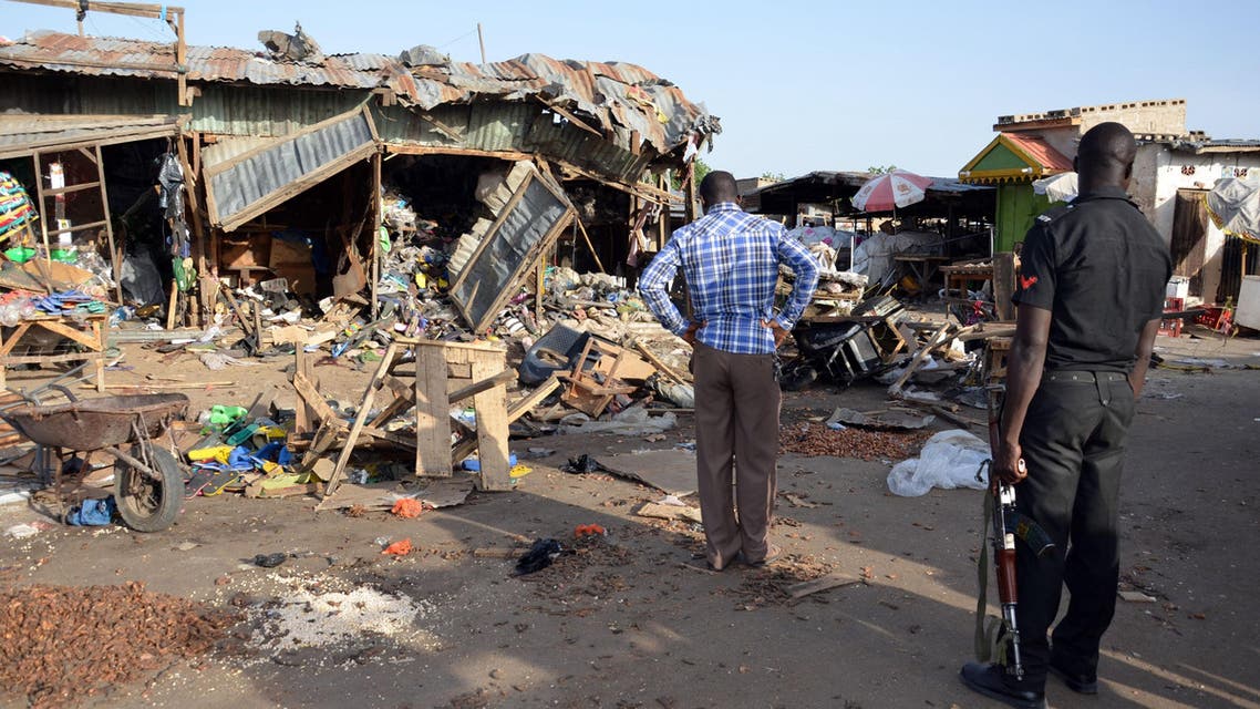 A police officer stands at the scene of a bombing after at least 20 people were killed when a young female suicide bomber detonated her explosives at a bus station in Maiduguri, northeast Nigeria, on June 22, 2015 AFP